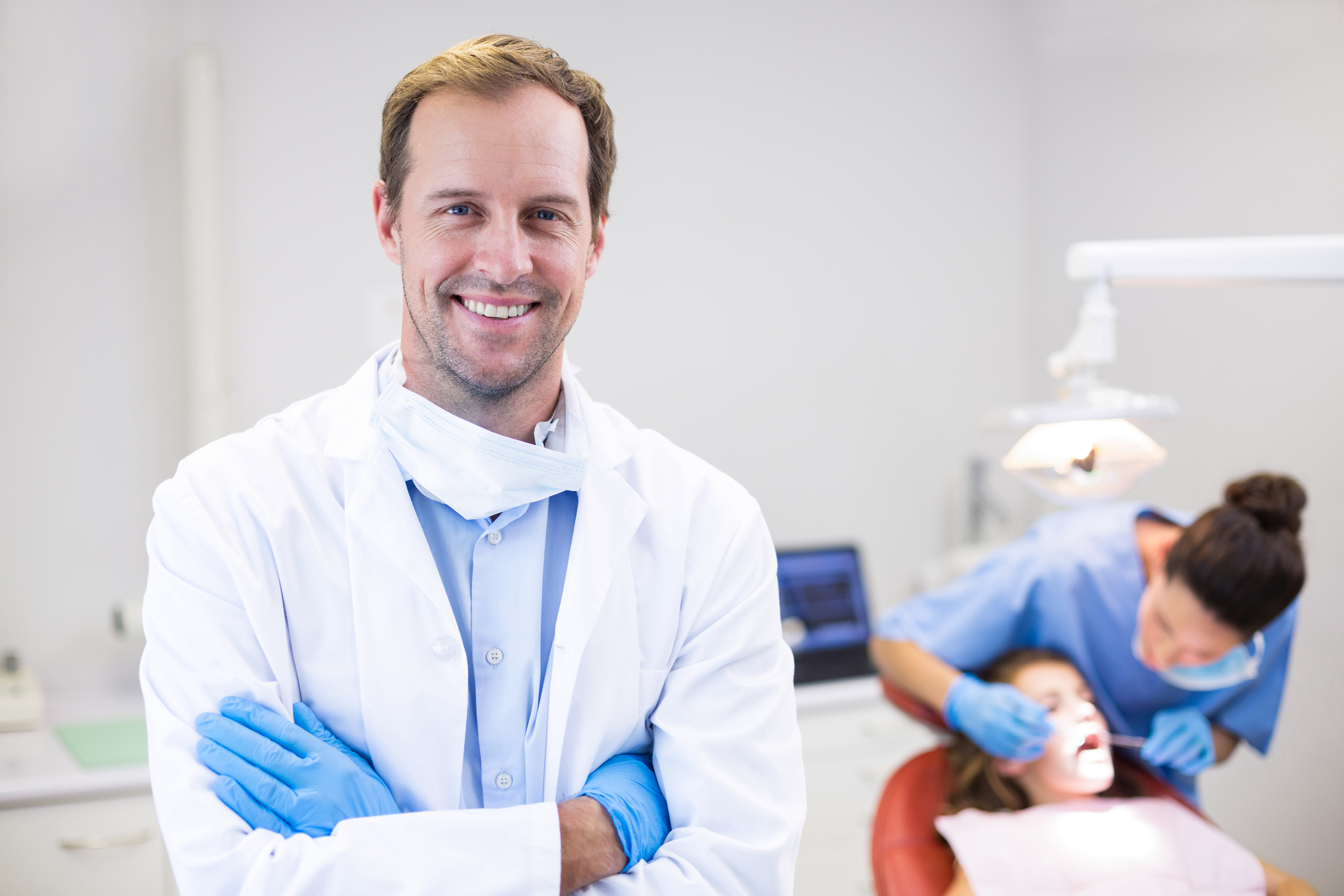 dentist crossing arms and smiling at the camera